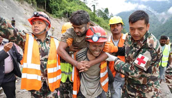 A man who survived is carried by members of a search and rescue team after they rescued alive two people who had been trapped inside a tunnel at the Trishuli-3A Hydropower Project following devastating floods and mudslides that struck the Bhotekoshi River in Rasuwa, Nepal, September 4, 2026.— Reuters