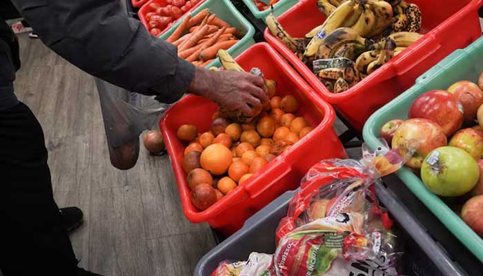 A community member grabs a piece of fruit at The Community Assistance Center food pantry, in Atlanta, Georgia, US April 12, 2023. — Reuters