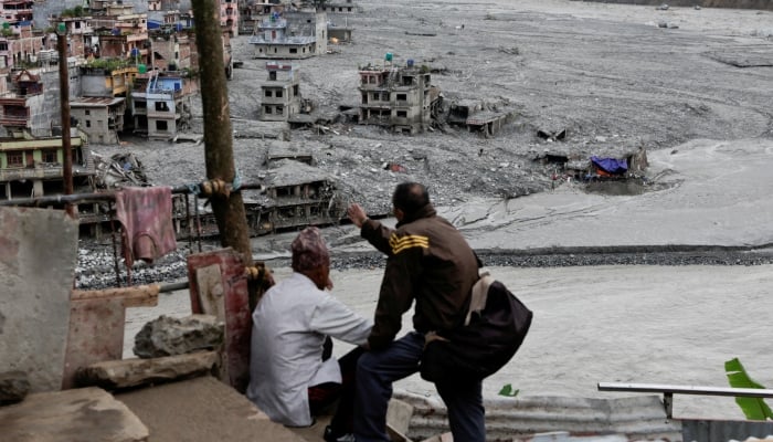 People look towards damaged houses following the deadly flash floods and a mudslide, in Trishuli, Nuwakot district, Nepal, September 5, 2026. — Reuters