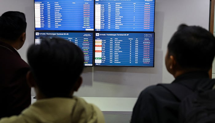 Stranded passengers look at screens as Soekarno Hatta International Airport closed its operations due to the eruption of the Mount Anak Krakatau volcano, in Tangerang, near Jakarta, Indonesia, September 6, 2026. — Reuters
