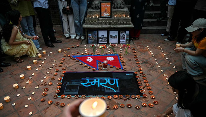 People take part in a candlelight vigil for Nepals flash flood victims in Kathmandu on September 5, 2026. — AFP