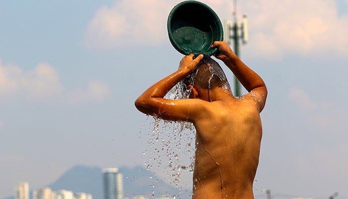 A boy cools off during a heatwave in Tegucigalpa City on May 12, 2026. — AFP