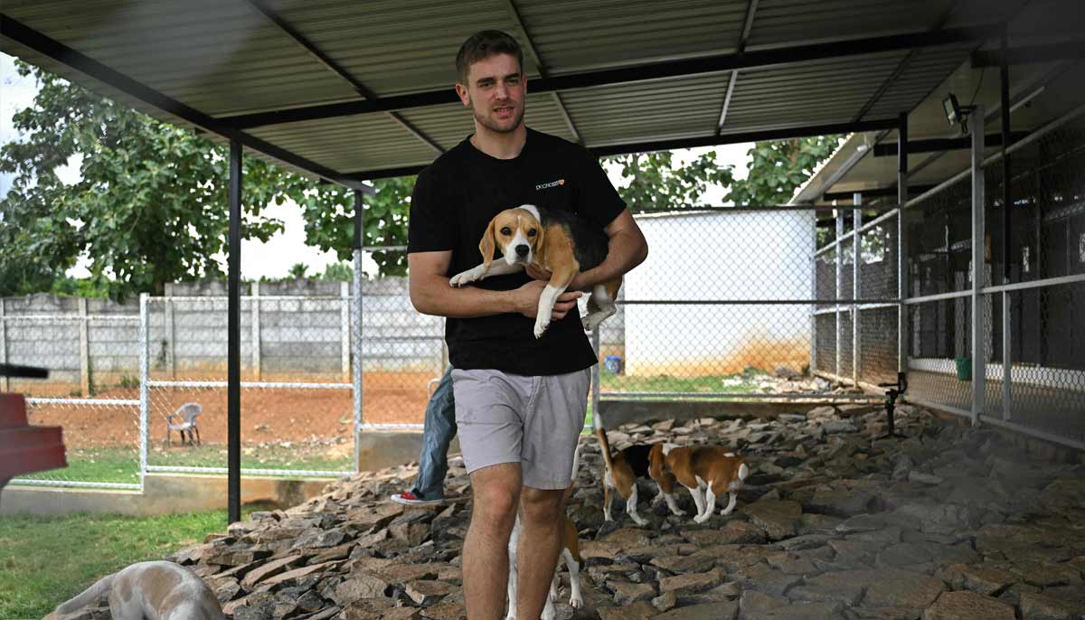 co-founder of the Dognosis Itamar Bitan holding a dog inside a kennel at his facility in Kempohalli village on the outskirts of Bengaluru.— AFP