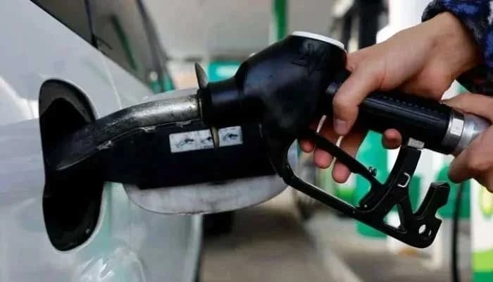 A person uses a fuel nozzle to fuel up a car at a petrol station in Vienna, Austria. — Reuters/File