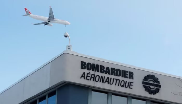A plane flies over a Bombardier plant in Montreal, Quebec, Canada on January 21, 2014.— Reuters