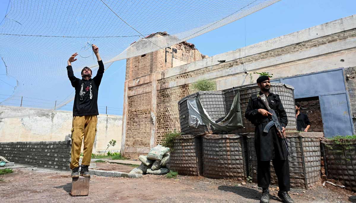 A security personnel fortifying a police post with Ukraine-style mesh barriers, as a new line of defence against militant drone and aerial attacks at Bara in Khyber Pakhtunkhwa.— AFP