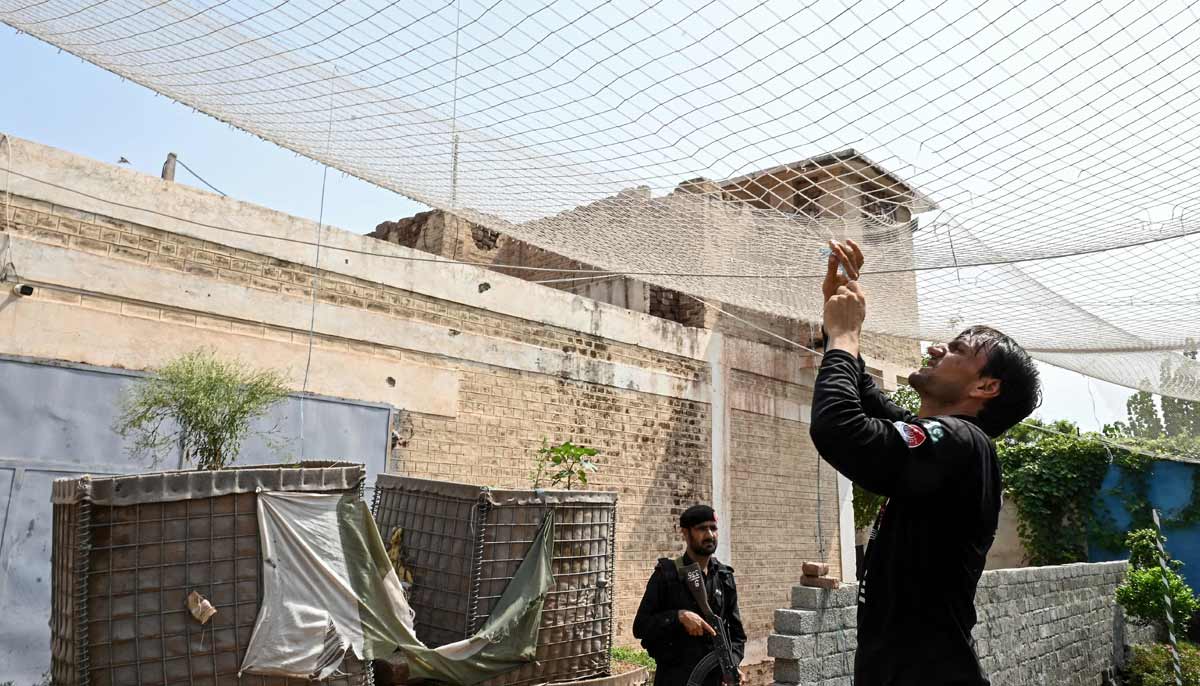 A security personnel fortifying a police post with Ukraine-style mesh barriers, as a new line of defence against militant drone and aerial attacks at Bara in Khyber Pakhtunkhwa.— AFP