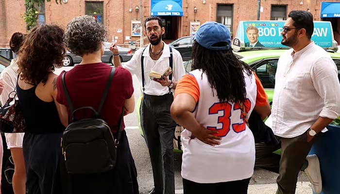 Asad Dandia conducts a guided tour about Malcolm X in the Harlem area of New York on August 22, 2026. — AFP