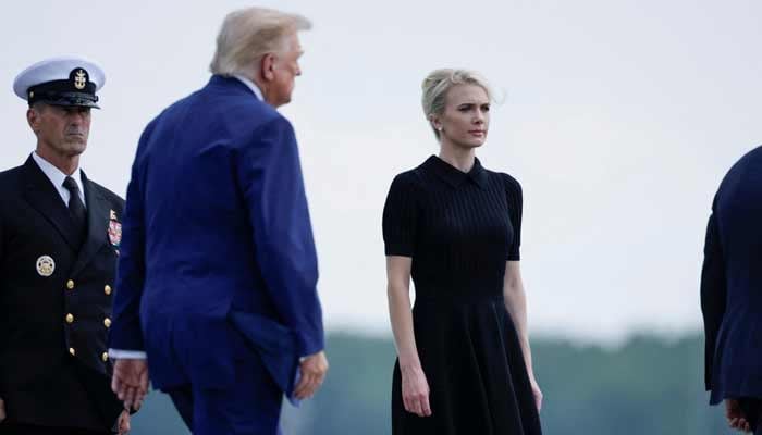 US President Trump walks by his Executive assistant Natalie Harp as they attend a dignified transfer of the remains of US Army service members at Dover Air Force Base in Dover, Delaware, US, July 22, 2026. — Reuters