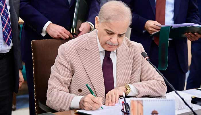 Prime Minister Shehbaz Sharif signs Annual Budget 2026-27 documents at Parliament House, Islamabad, on June 12, 2026. —PID