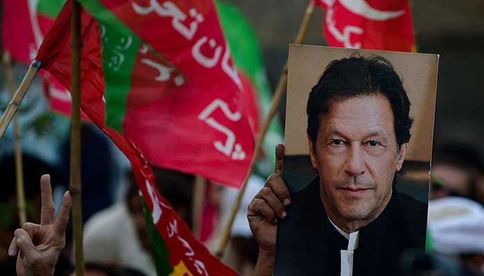 Activists of the opposition party Pakistan Tehreek-e-Insaf (PTI) take part in an anti-government rally demanding early elections in Karachi, October 28, 2022. — AFP
