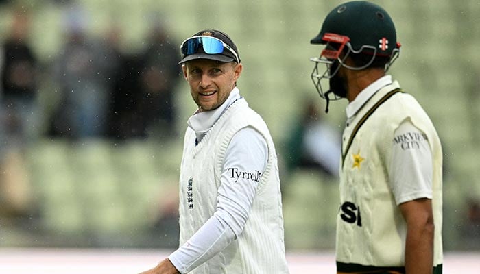 Englands Joe Root and Pakistans Shan Masood walk back to the pavilion during a rain delay on day two of the third test match between England and Pakistan at Edgbaston cricket ground in Birmingham, central England, September 10, 2026. — AFP