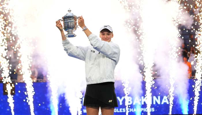 Kazakhstans Elena Rybakina celebrates with the winners trophy after her final match against Belarus Aryna Sabalenka