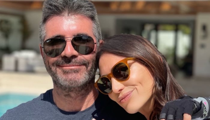 At one point, Simon, 66, put on a cosy display with Lauren at a cafe from summer getaway