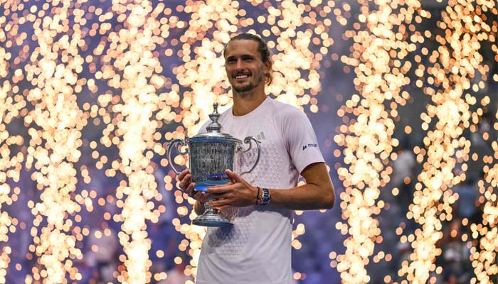 Germanys Alexander Zverev holds the trophy after defeating USAs Ben Shelton in the mens singles final tennis match on day fifteen of the US Open tennis tournament at the USTA Billie Jean King National Tennis Centre in New York on September 13, 2026. — AFP