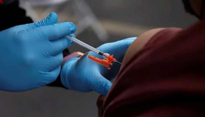A health care administer gives the vaccine dose to a person. — Reuters/File