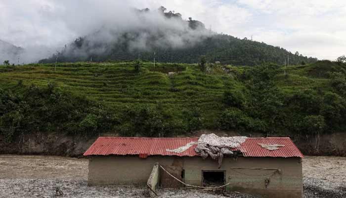 Mud partially buries a damaged house following deadly flash floods and a mudslide, in Dhading district, Nepal, September 14, 2026.— Reuters