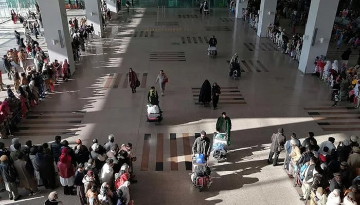People gather to receive passengers at the international arrival area of the Islamabad International Airport in Islamabad on February 3, 2020. — AFP