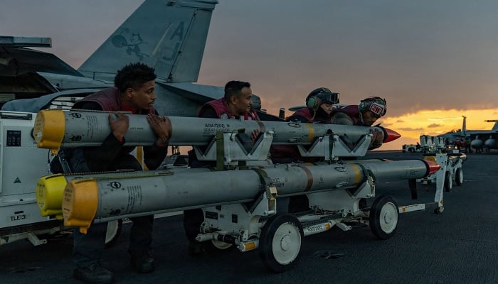 US Navy sailors move ordnance on the flight deck of the aircraft carrier USS Gerald R. Ford at an undisclosed location.— Reuters/File