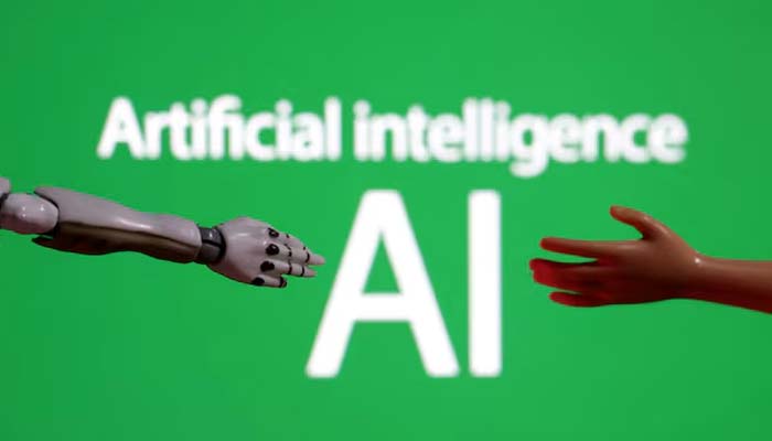 Words reading Artificial intelligence AI, a miniature of robot and toy hand are pictured in this illustration taken on December 14, 2023. — Reuters