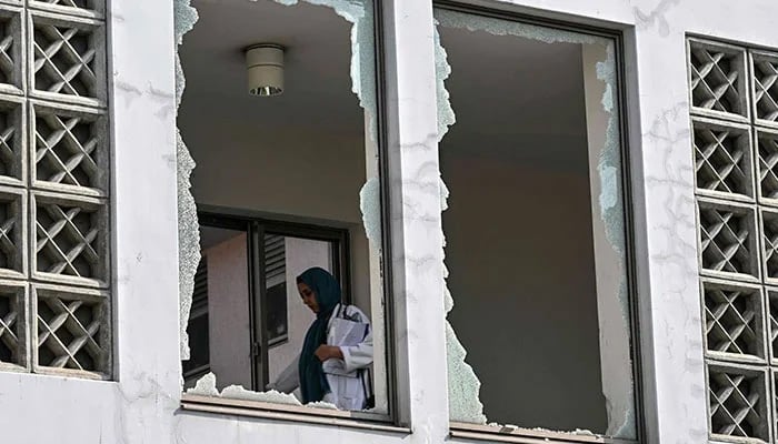 A medical staff member walks past a damaged corridor at the site, a day after a fire at the Mother and Child Health ward of the Pakistan Institute of Medical Sciences (Pims) Hospital in Islamabad on August 27, 2026. — AFP