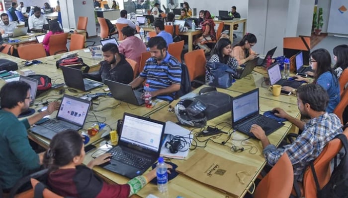 This photograph shows employees of online marketplace company in Karachi. — AFP/File