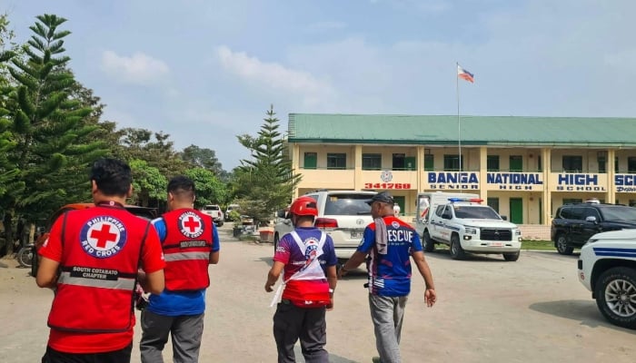 Emergency personnel walk at a site of a deadly shooting at a school in Banga, South Cotabato, Philippines, September 18, 2026. — Reuters