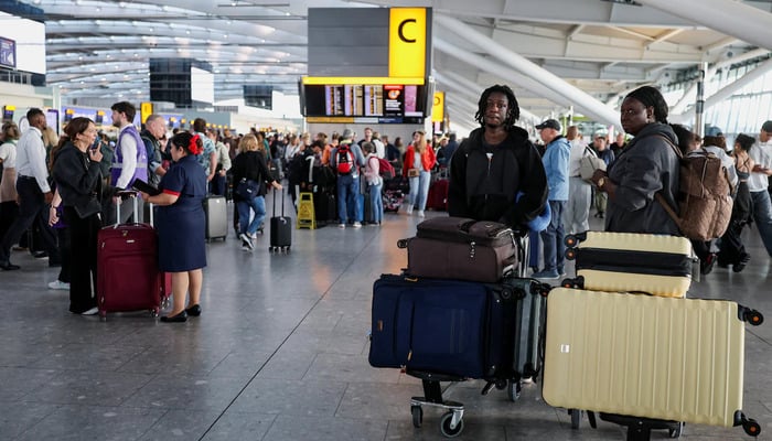 Stranded passengers gather after some departing flights were cancelled, at Heathrow Airports Terminal 5 in London, Britain, September 8, 2026. — Reuters