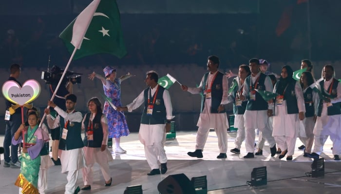Members of Pakistans delegation wave the countrys national flag during a parade at the opening ceremony of the 2026 Asian Games at Paloma Mizuho Stadium in Nagoya, Japan, September 19, 2026. — AFP