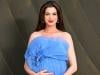 Anne Hathaway shows off baby bump in at 'Verity' press junket