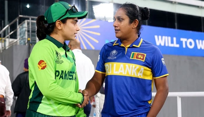 Sri Lankan cricketer and captain Chamari Athapaththu (in the blue Sri Lanka jersey) shaking hands with Pakistans Fatima Sana. — AFP/File