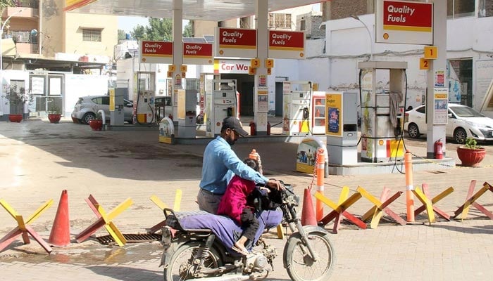 A person outside a closed petrol pump in Hyderabad on February 27, 2023. — Online