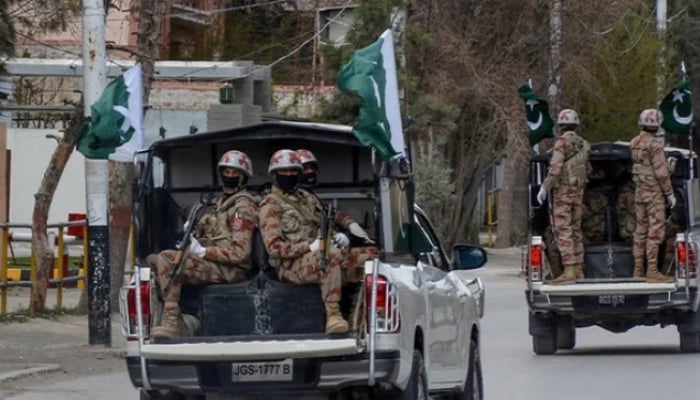 Security personnel patrol with vehicles on a street in Quetta, Balochistan. — AFP/File