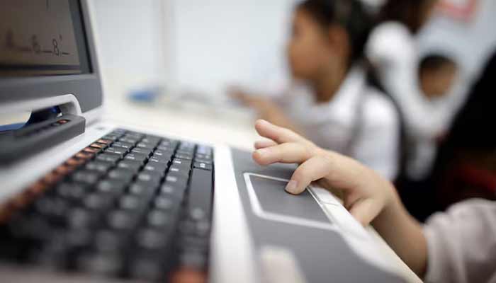 A child uses a laptop at a school. — Reuters