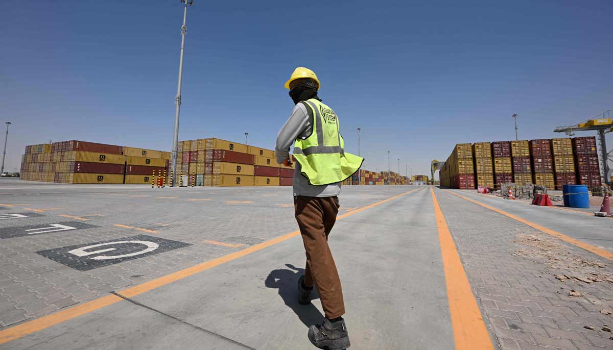 A worker walks towards stacks of shipping containers at the port of Umm Qasr in southern Iraq on September 17, 2026.— AFP
