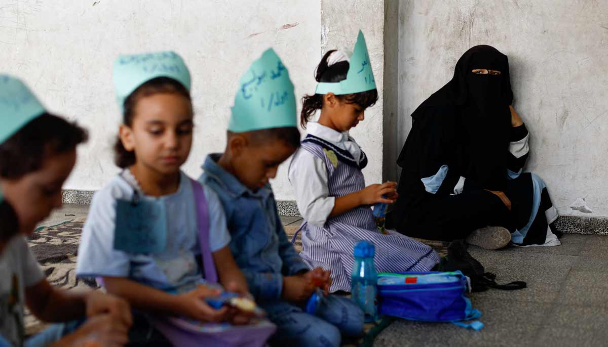 A woman sits, as Palestinian students attend their first day of the new school year at an UNRWA school, in Nuseirat, in the central Gaza Strip, September 19, 2026.— Reuters