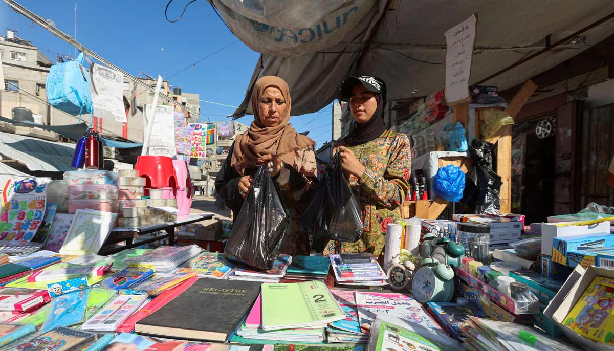 Displaced Palestinian student Samar Abu Salmi, 15, and her mother Ghalia Abu Salmi, 53, look at stationery at a stall in Khan Younis, in the southern Gaza Strip, September 13, 2026.— Reuters