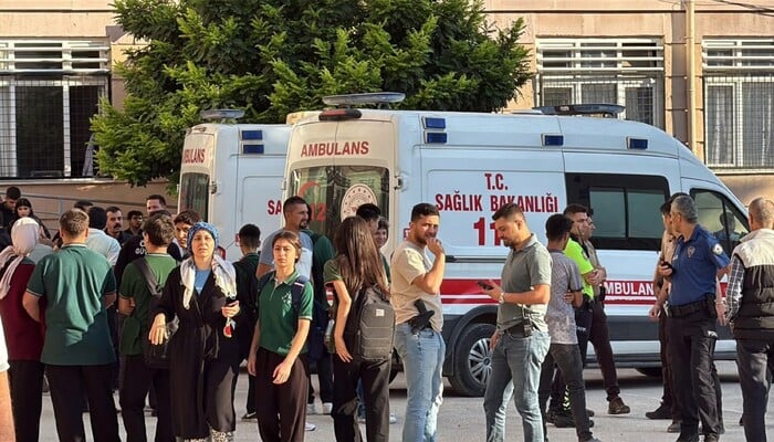 Ambulances and police officers waiting in front of a high school outside which a gunman opened fire in Turgutlu.  — AFP