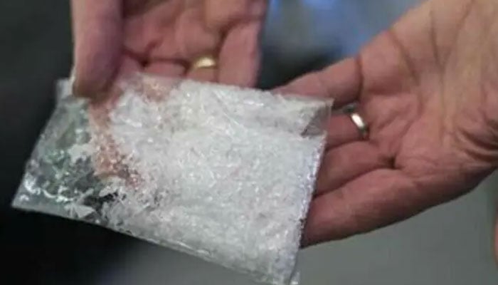 This representational image shows a woman holds a bag of crystal meth. — Reuters/File