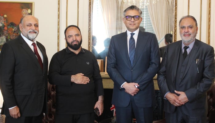 Pakistan’s High Commissioner to the United Kingdom Tipu Usman (centre right) poses during meeting with Islamabad-based businessman Maqbool Hussain Awan at the Pakistan High Commission. — Reporter