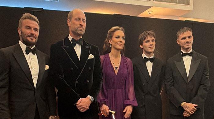 Prince William's velvet jacket catches Tom Cruise's eye as he reunites with David Beckham