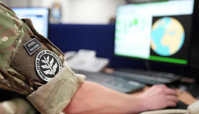 Space operators take part in a simulation of a missile warning event in the simulation room at RAF Fylingdales, which provides continuous ballistic missile early warning and space surveillance services. — Reuters