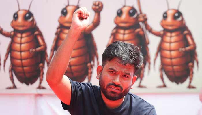 Abhijeet Dipke, head of the Cockroach Janta Party (CJP), gestures to the supporters of the CJP during a sit-in protest demanding the resignation of Indian Education Minister Dharmendra Pradhan, in New Delhi, India, June 20, 2026.— Reuters
