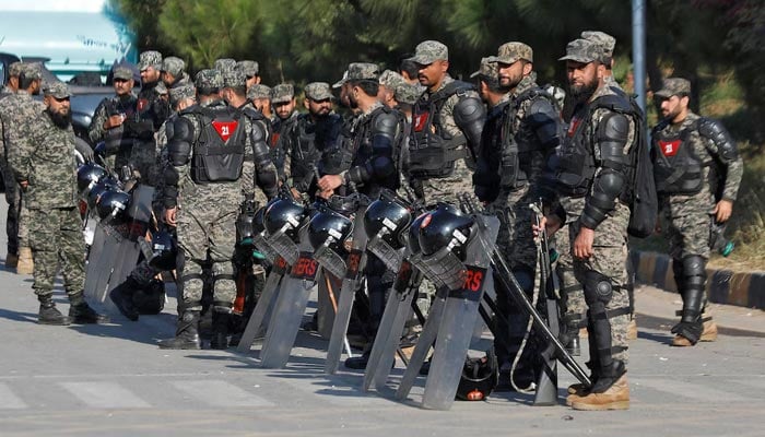Pakistani Rangers in riot gear stand guard alongside a road to prevent a rally by Pakistan Tehreek-e-Insaf (PTI) supporters in Islamabad, November 25, 2024. — Reuters