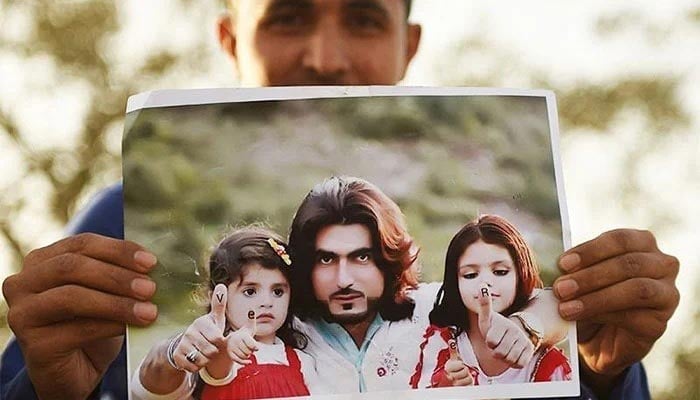 A protester holds a photograph of 23-year-old Naqeebullah Mehsud during a protest in Karachi on January 23, 2018. — AFP