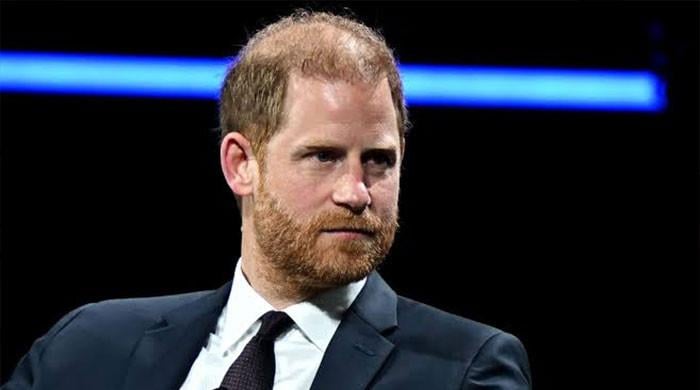 Prince Harry kisses the ground after emotional skydive honouring 102-year-old veteran