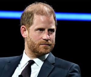 Prince Harry kisses the ground after emotional skydive honouring 102-year-old veteran