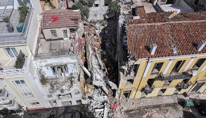 A drone view shows an old building, partially collapsed following an explosion, in the Plaka area, which is popular with tourists, in central Athens, Greece, September 25, 2026. — Reuters