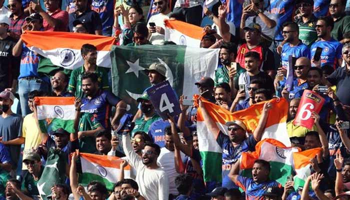 Pakistani and Indian fans are pictured with flags inside the stadium before the match. — Reuters/File