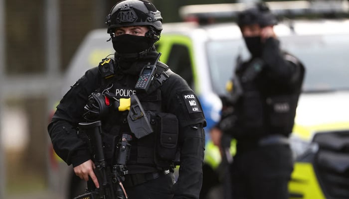 An armed police officer stands guards on a road outside the perimeter of the RAF Fairford airbase, in Fairford, Gloucestershire, Britain, September 28, 2026. — Reuters